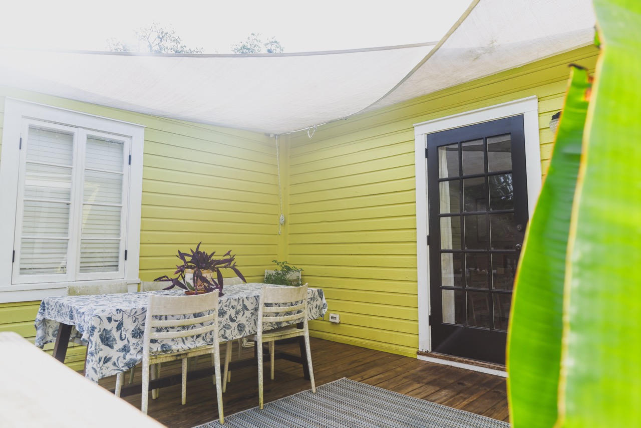 Back patio dining table under sail shade
